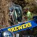 Brewer's driver Patrick Birmingham hooks a chain to the front of an SUV found in wooded area next to Penske Truck Rental on Plymouth Rd. on Thursday. Melanie Maxwell I AnnArbor.com